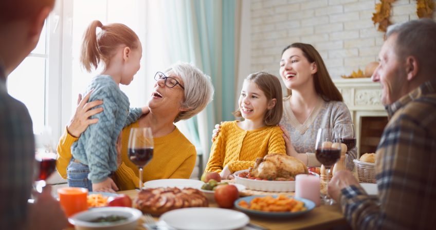 Family at the table for thanksgiving dinner.