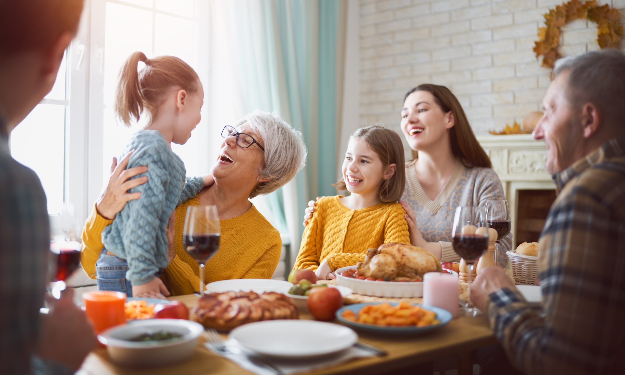 Family at the table for thanksgiving dinner.