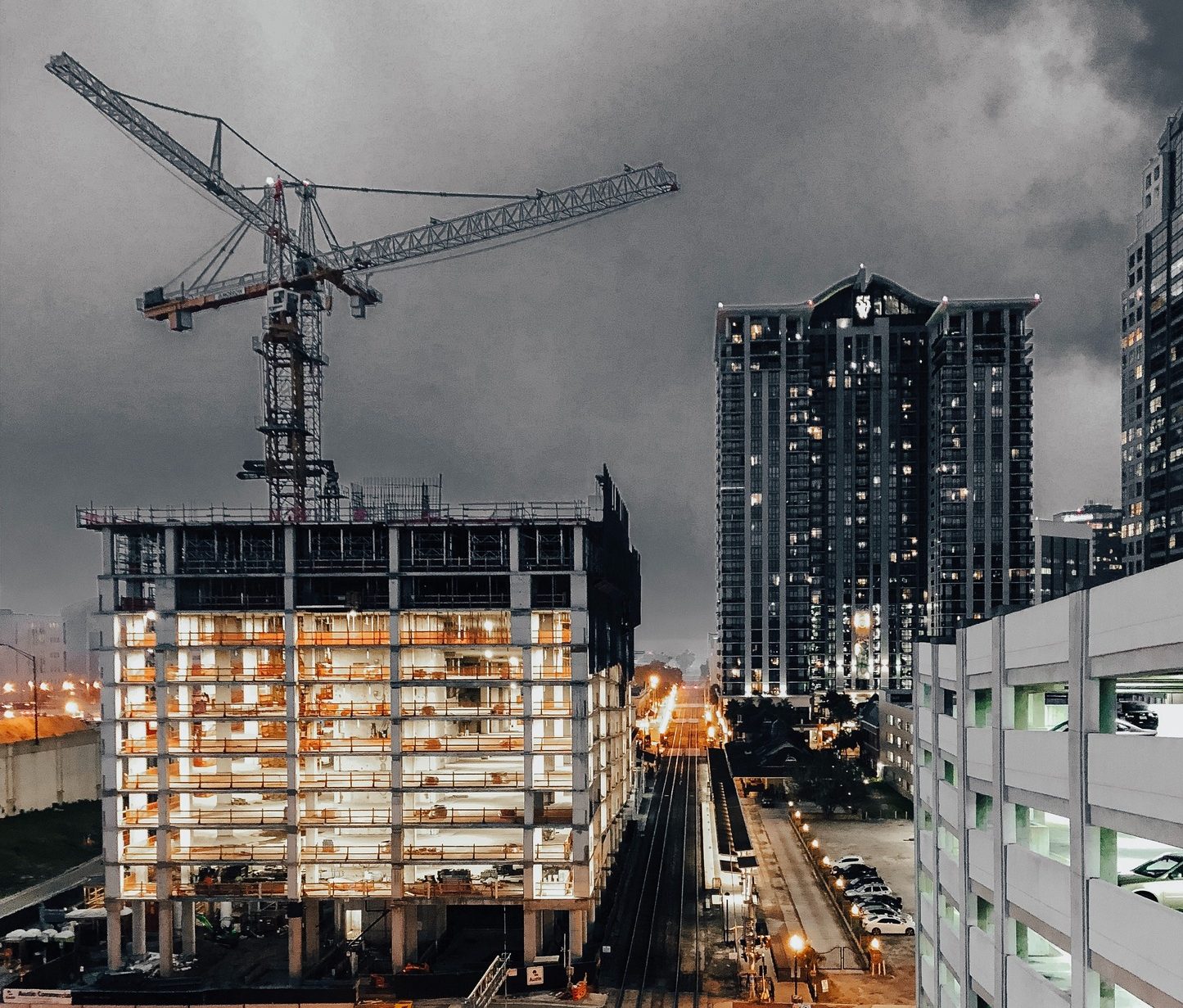 urban high rise buildings in construction on a dark gloomy weather.