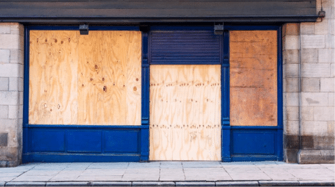 Business owner reviewing insurance policy after disaster damage